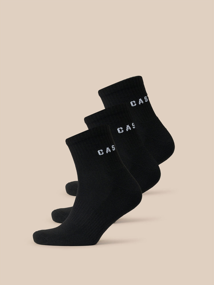 Three black quarter socks stacked diagonally with white CASTORE lettering