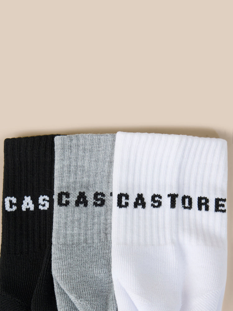 Three pack of Castore Druce quarter socks in black gray and white with bold Castore lettering