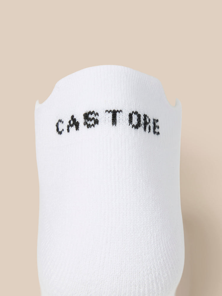 Close up of a white Castore X Tufnell trainer liner sock with CASTORE lettering.
