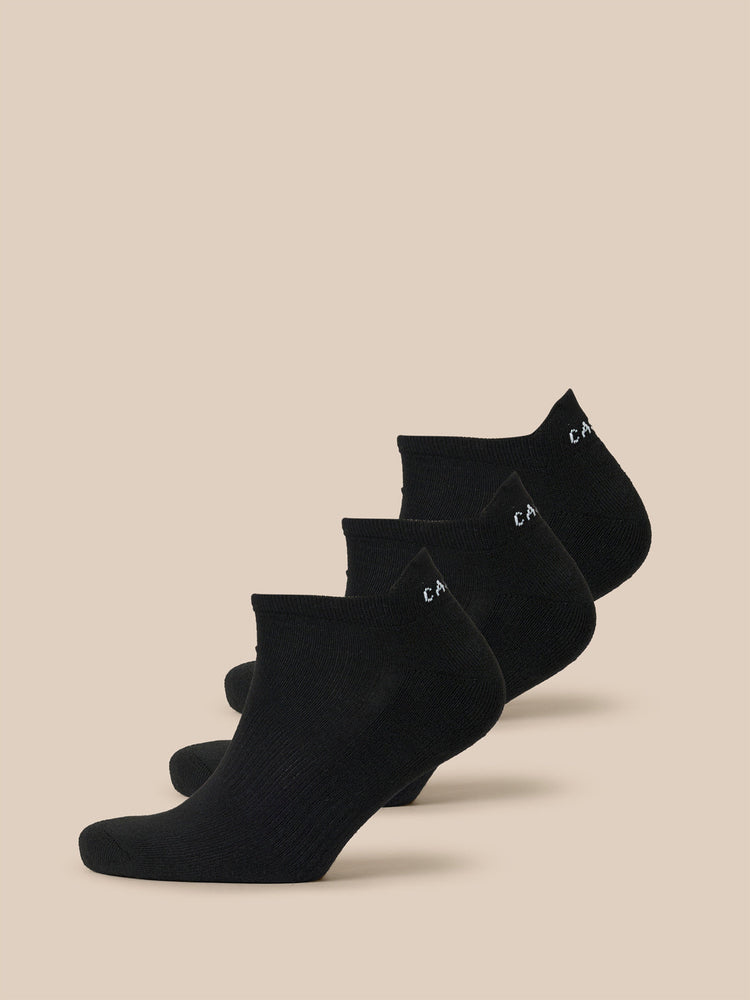 Black Castore X Millburn three-pack trainer liner socks arranged in a row