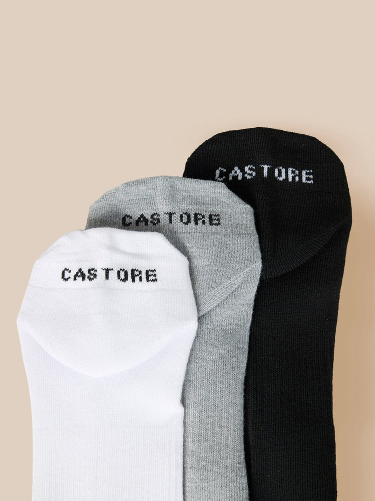 Three Castore X Cowdrey trainer liner socks in white gray and black with CASTORE branding.