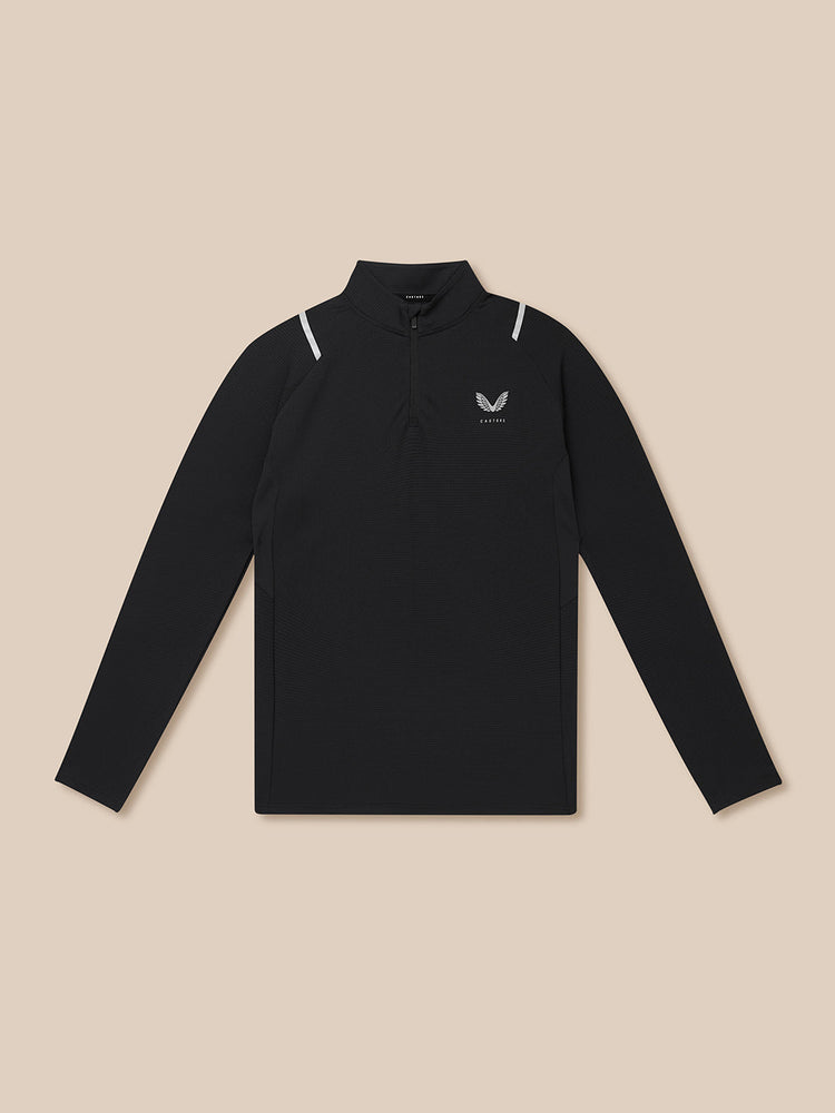 Black long-sleeve shirt with a small logo on a beige background