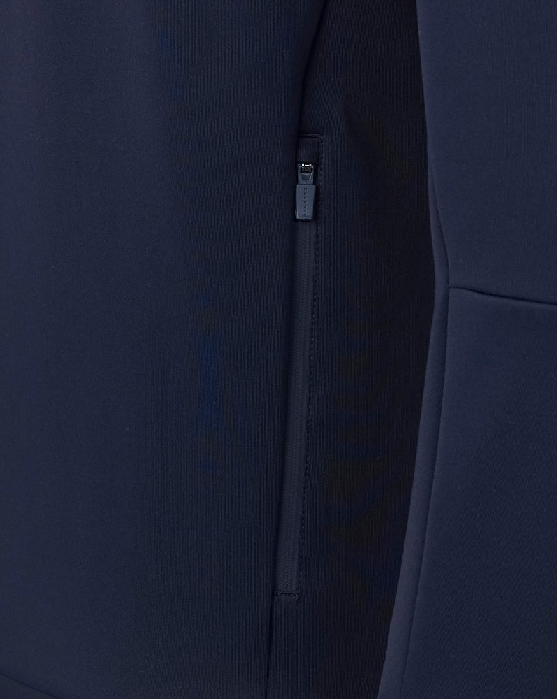 Navy blue coat with a zipper detail on a dark background