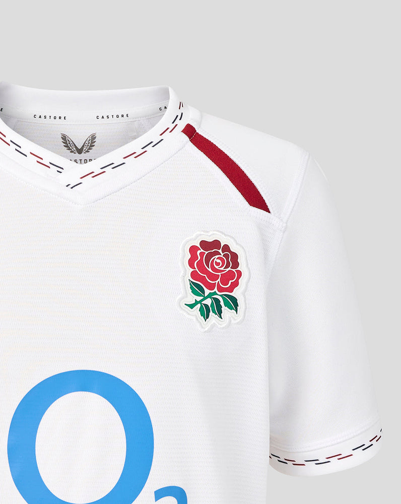 White sports jersey with a rose emblem and blue letter 'O' on a light gray background