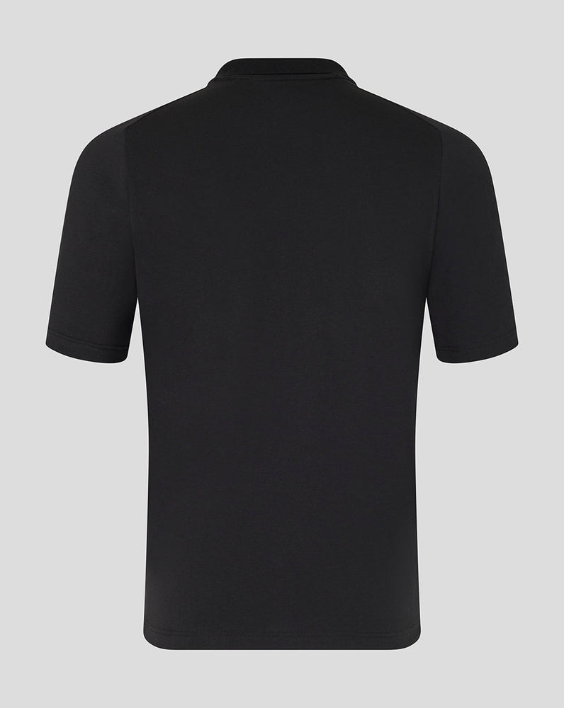 Black polo shirt on a light gray background