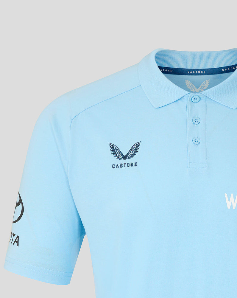 Light blue polo shirt with branding on a light gray background