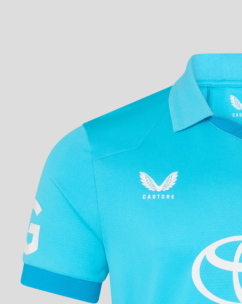Light blue polo shirt with 'Castore' branding on a gray background