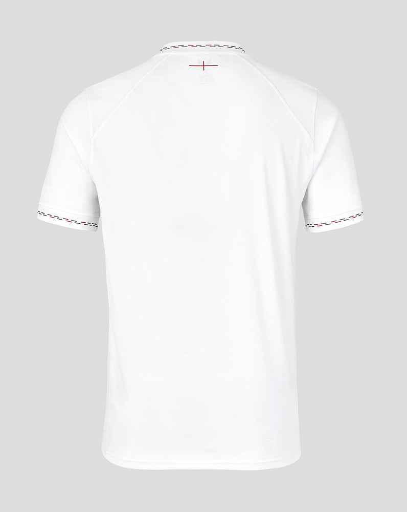 White t-shirt with decorative trim on a light gray background