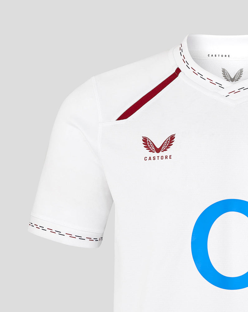 White sports jersey with red accents and 'Castore' branding on a light gray background