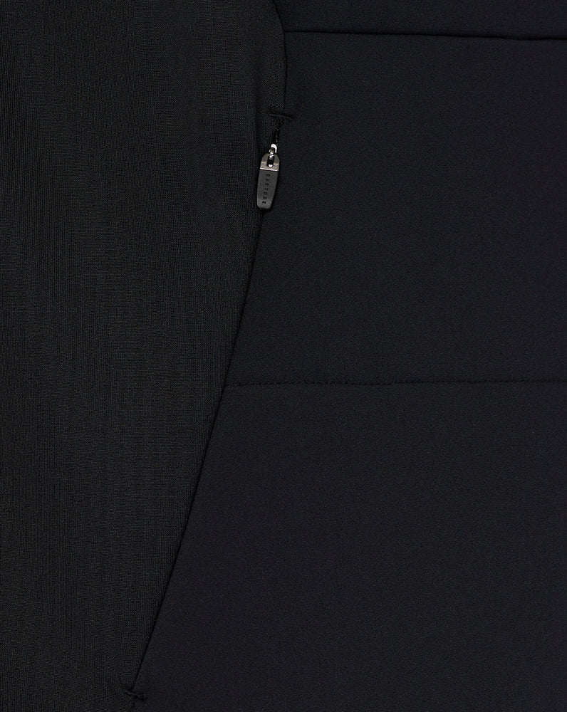 Close-up of a black jacket with a zipper detail on a plain background