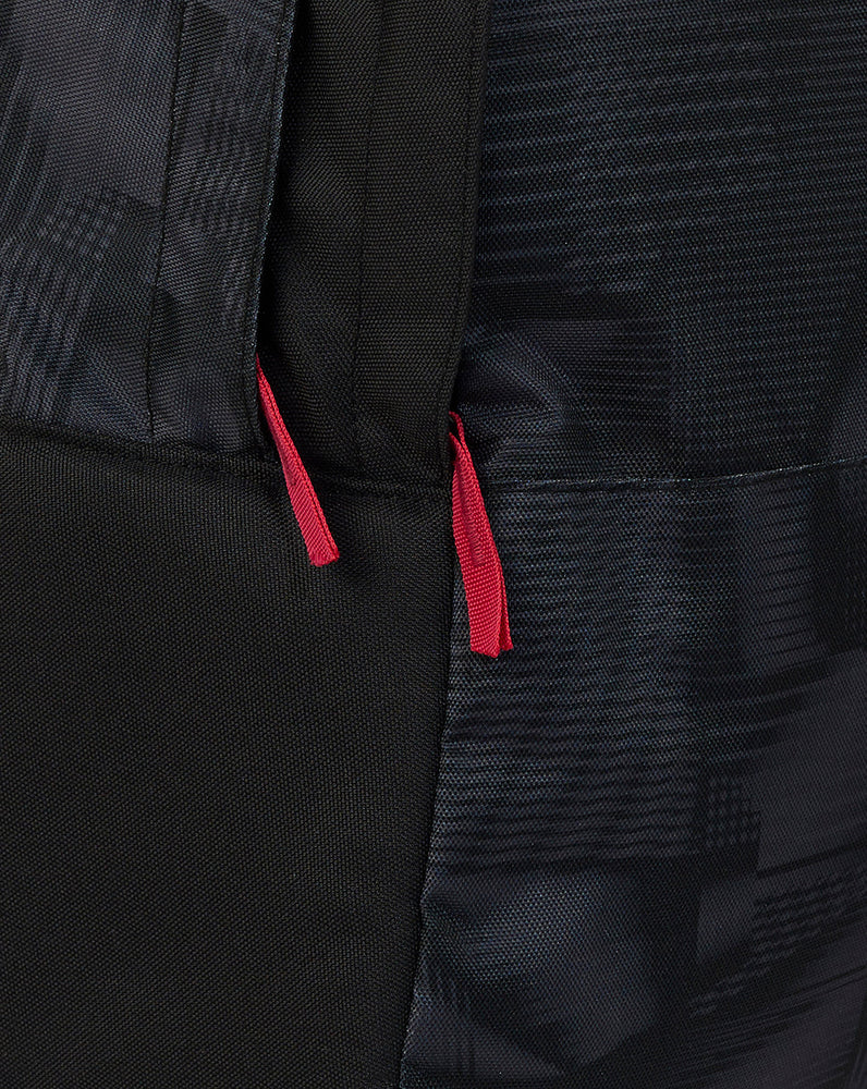 Close-up of a black bag with red drawstrings on a dark background