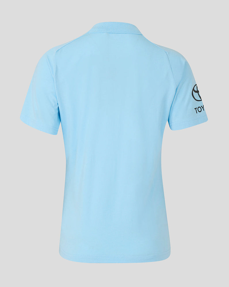 Light blue polo shirt with a brand logo on the sleeve against a light gray background
