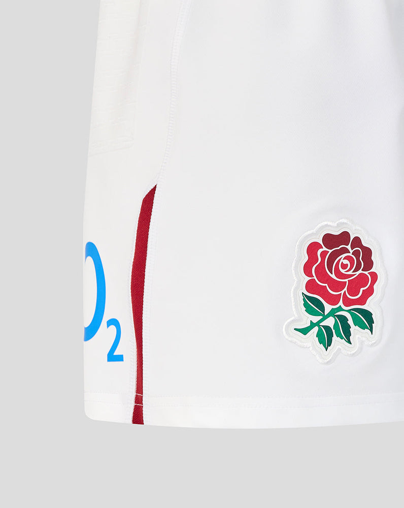 White sports kit with red rose emblem on a gray background