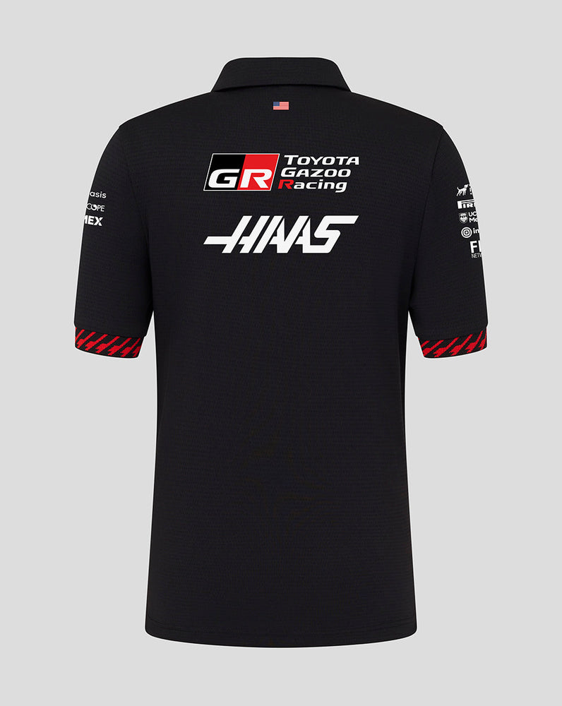 Black polo shirt with Toyota Gazoo Racing and Haas logos on a gray background