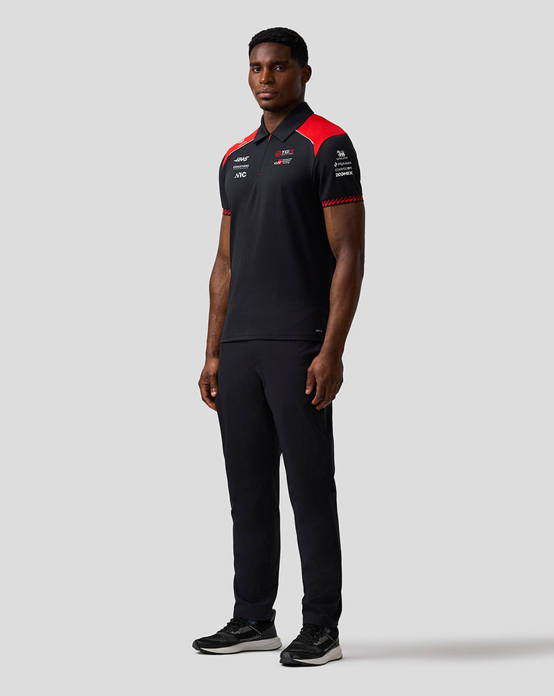 Person wearing a black and red sports outfit on a white background