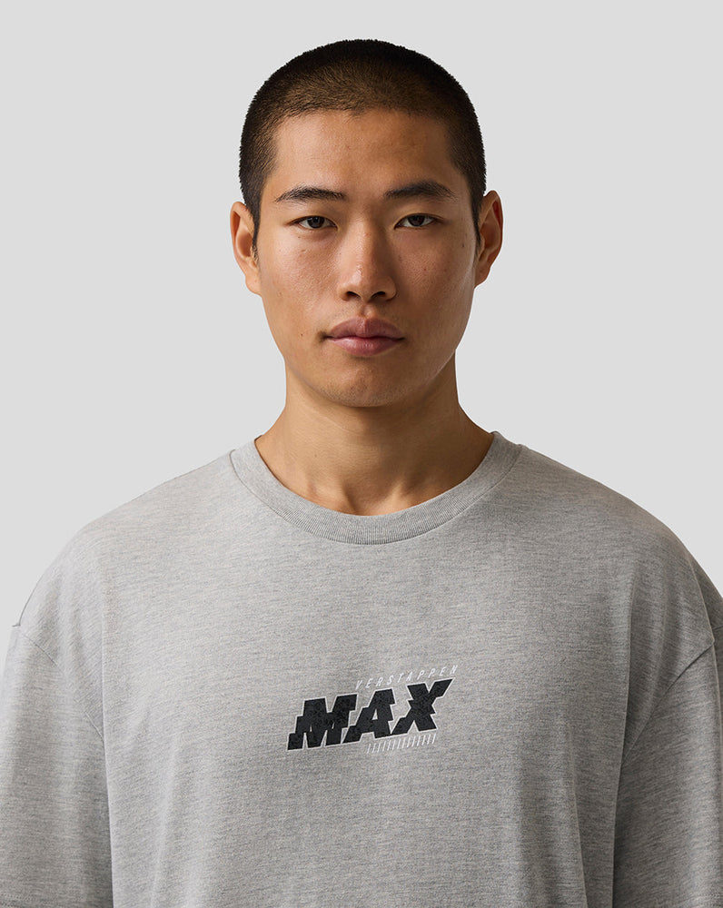 Man wearing a gray sweatshirt with 'MAX' logo on a plain background